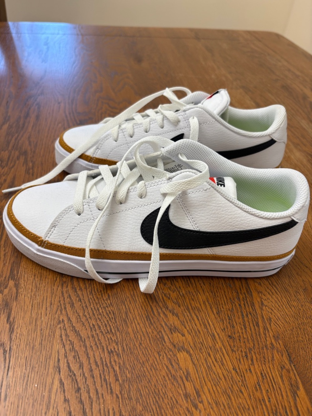 Nike White Low-Top Sneakers with Black Swoosh and Brown Trim